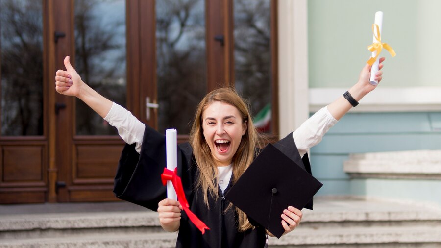 A student celebrating holding degree in hand on a convocation occasion