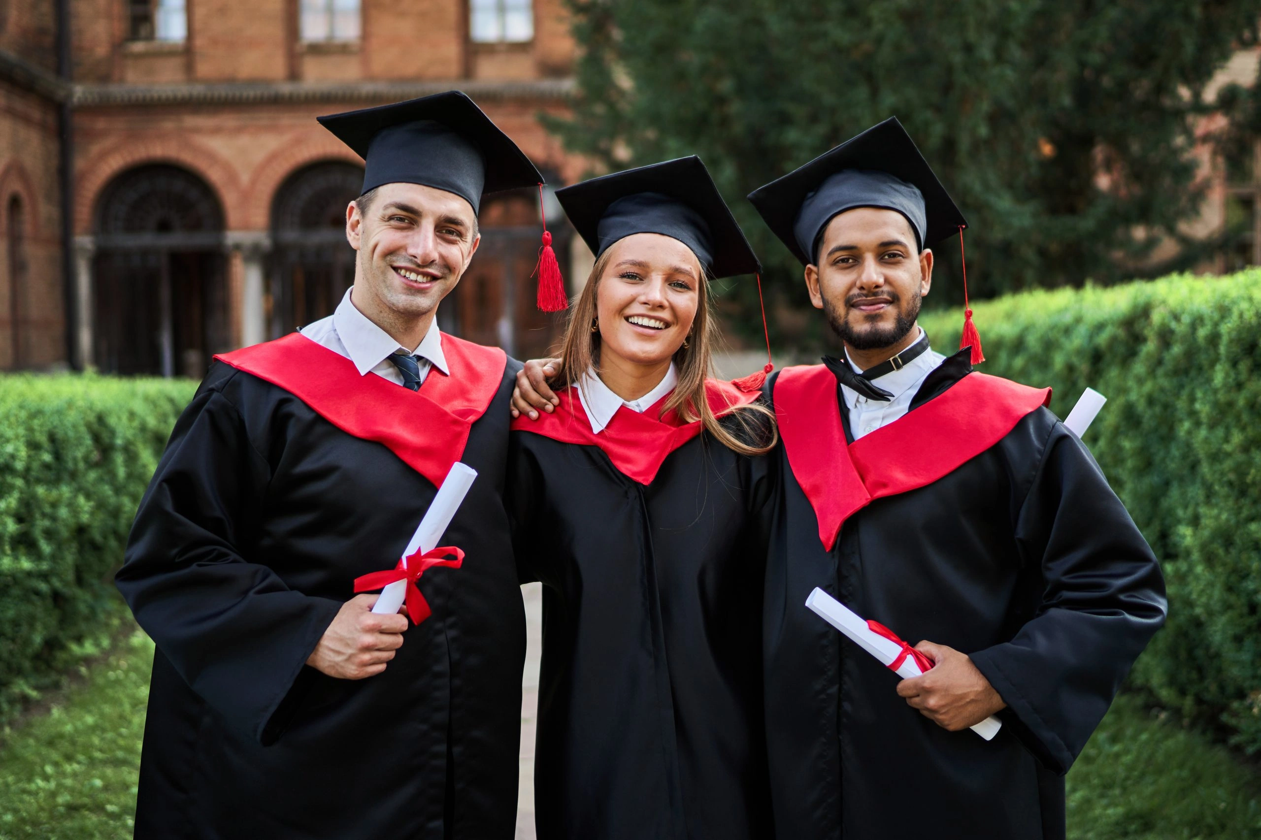 Three scholars showing up their degrees on convocation